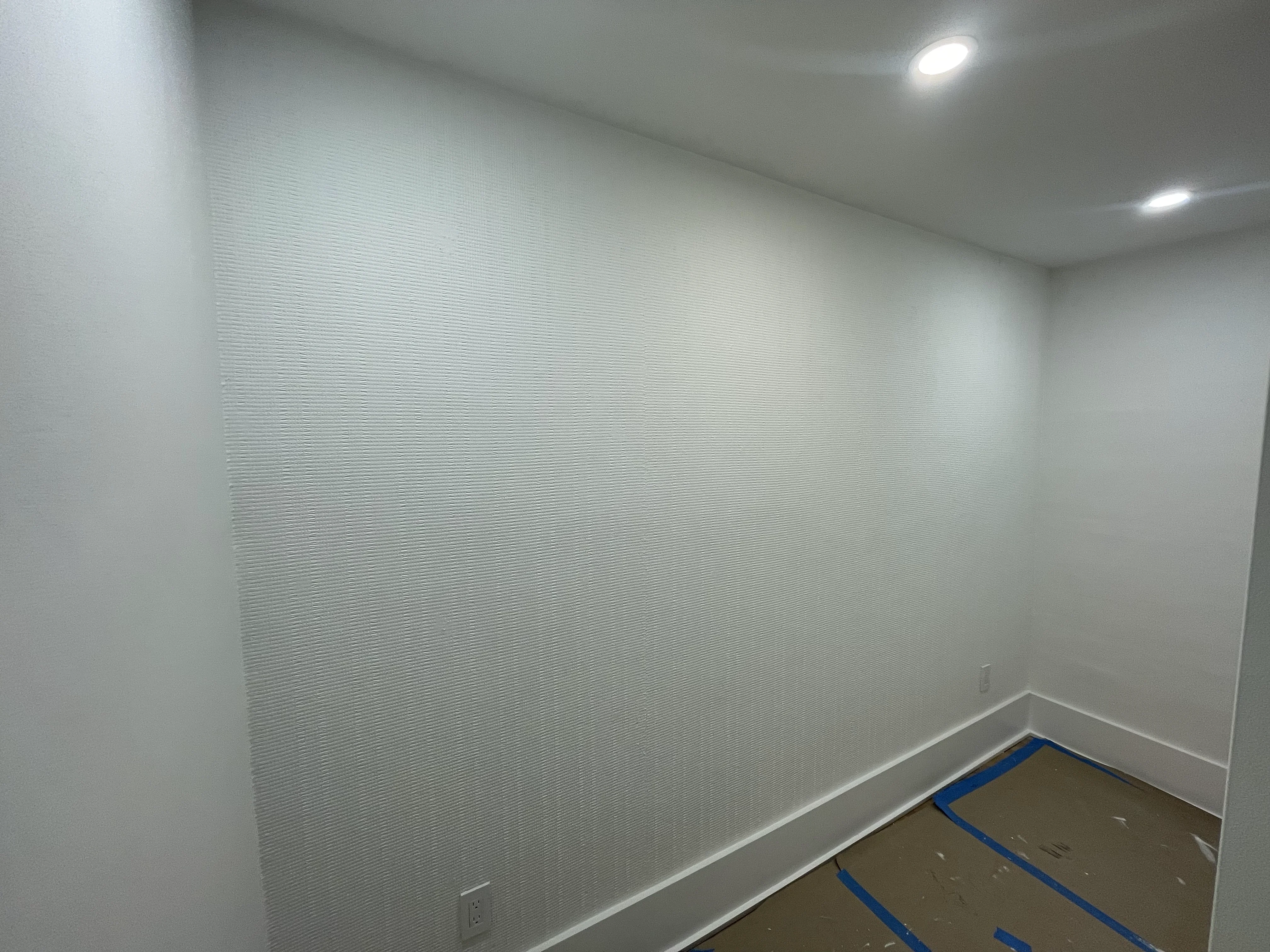 Finished white room with recessed lighting and trim work