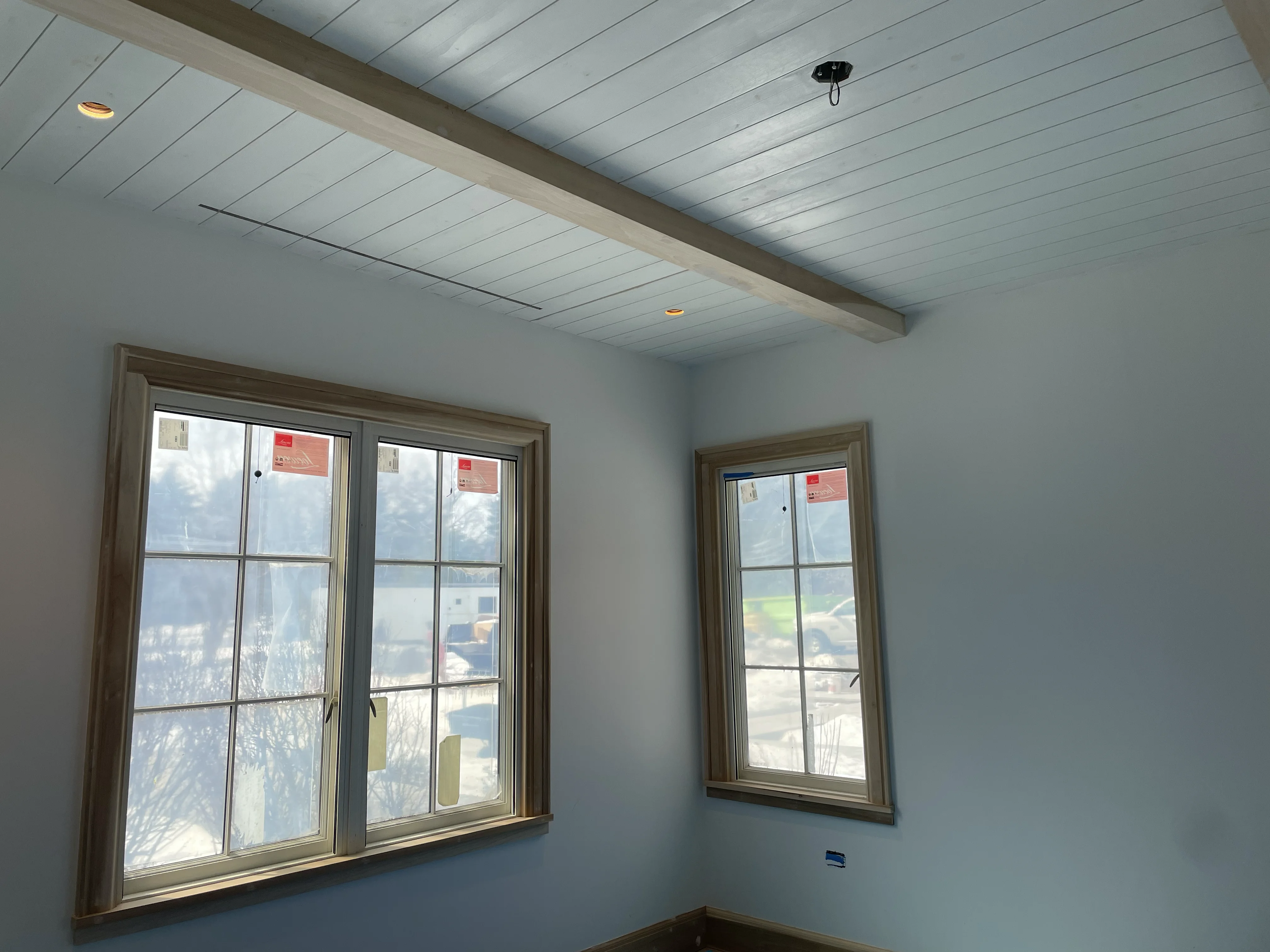 Shiplap ceiling with exposed beam installed by Gerhard and Sons